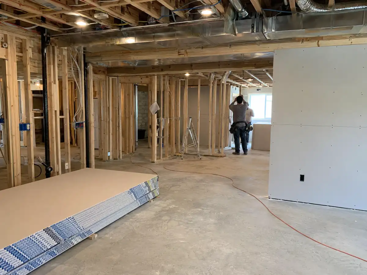 Basement finishing in progress — framing, drywall, and finished space in a Colorado home